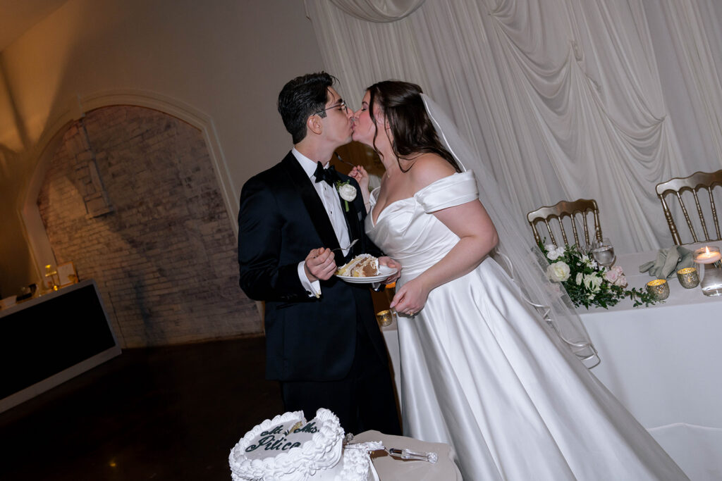 cute picture of the newlyweds kissing at their wedding reception