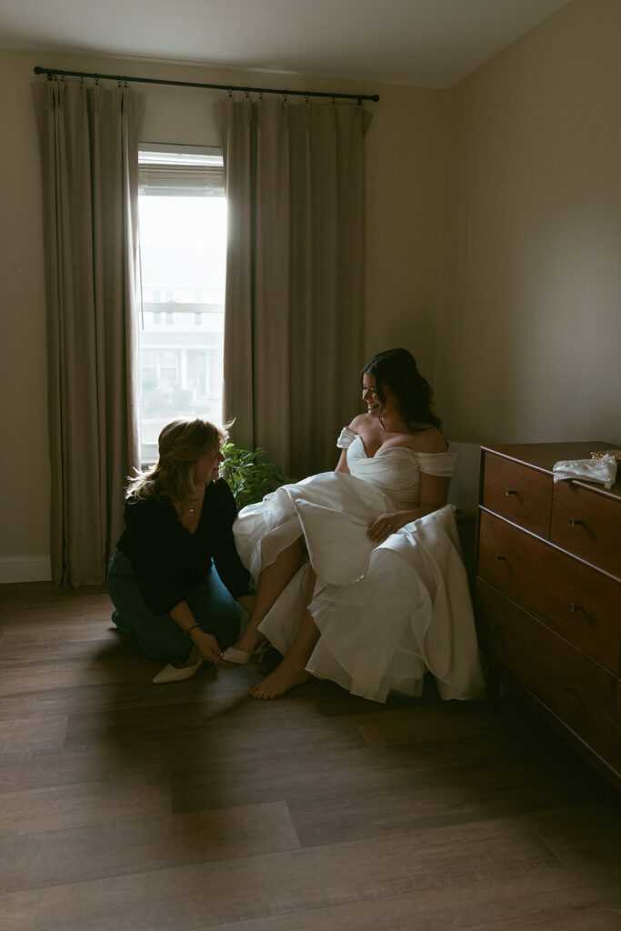 Mother of the bride helping her get ready for the ceremony