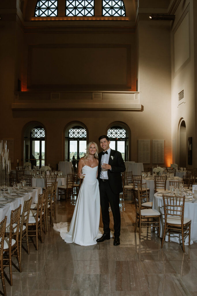 newlyweds smiling at the camera during their photoshoot
