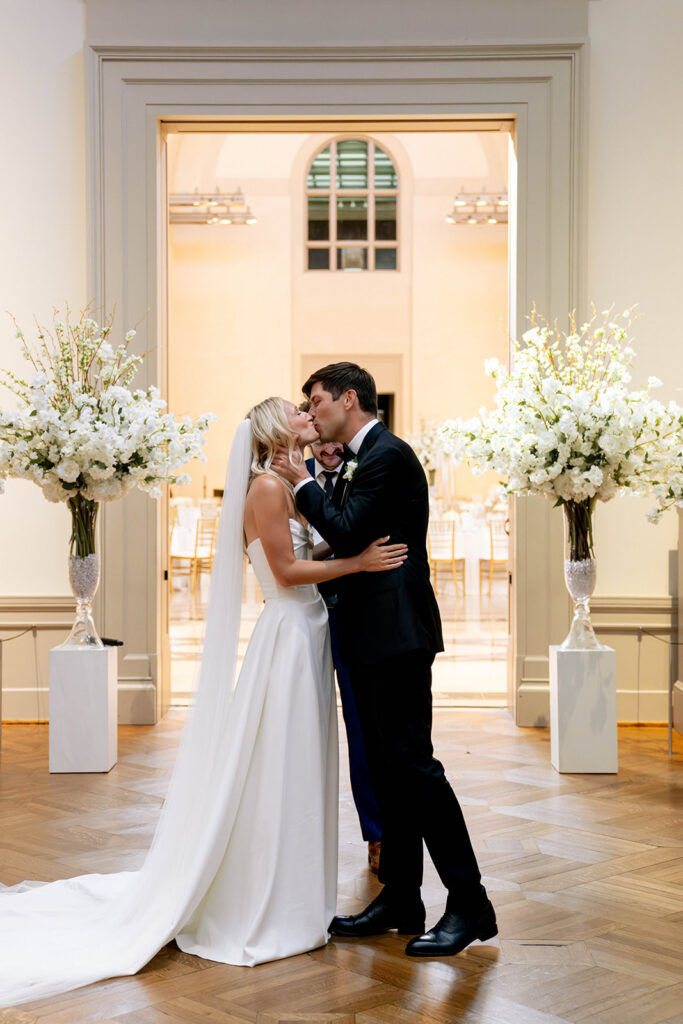 newlyweds kissing after their wedding ceremony