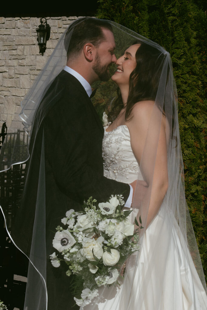 portrait of the bride and groom laughing with each other during their photoshoot