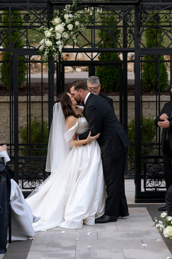 newlyweds kissing after their wedding reception