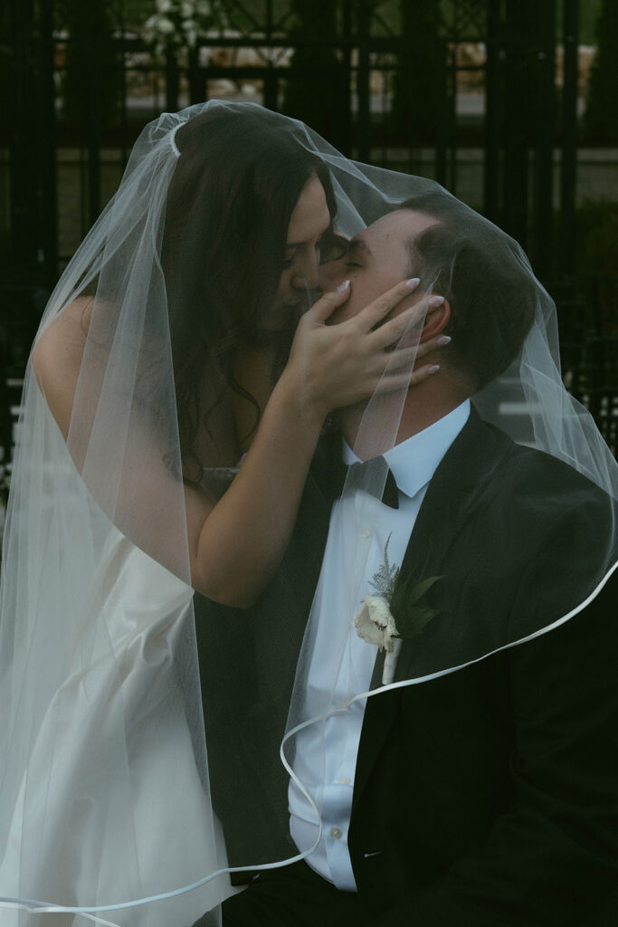 romantic portrait of the bride and groom kissing
