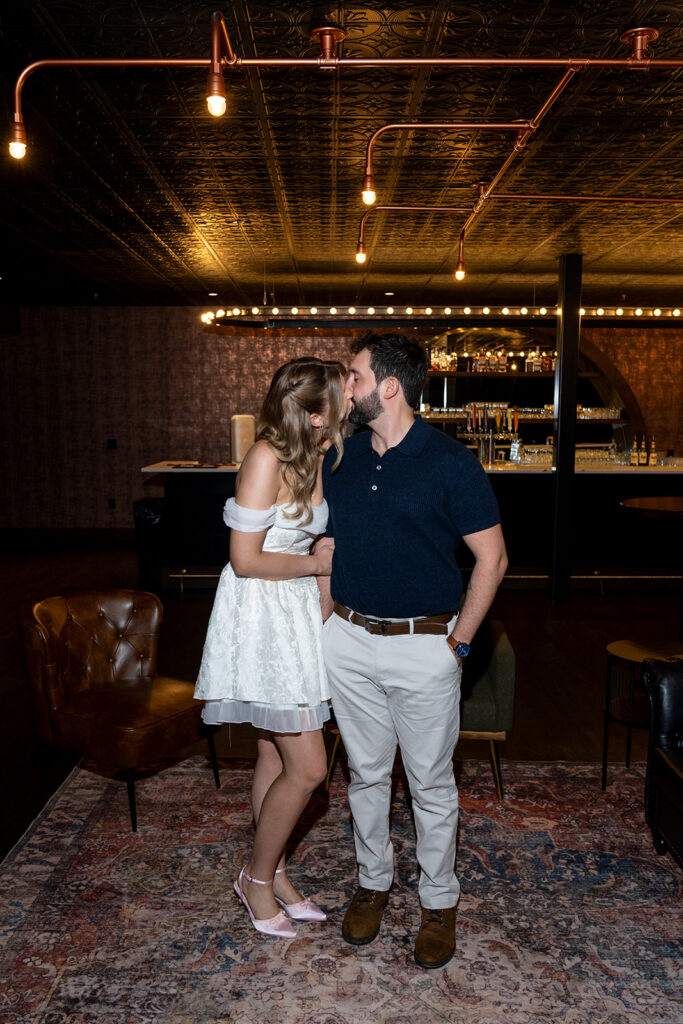 newly engaged couple kissing