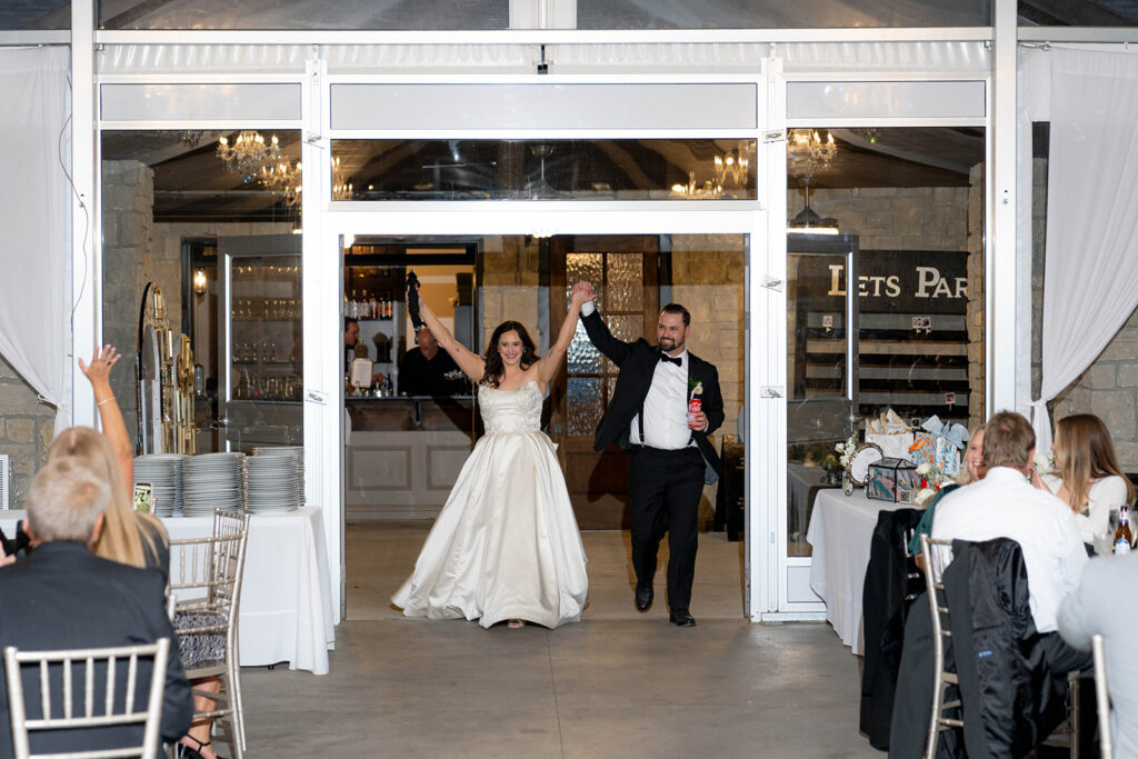 newlyweds entering their wedding reception
