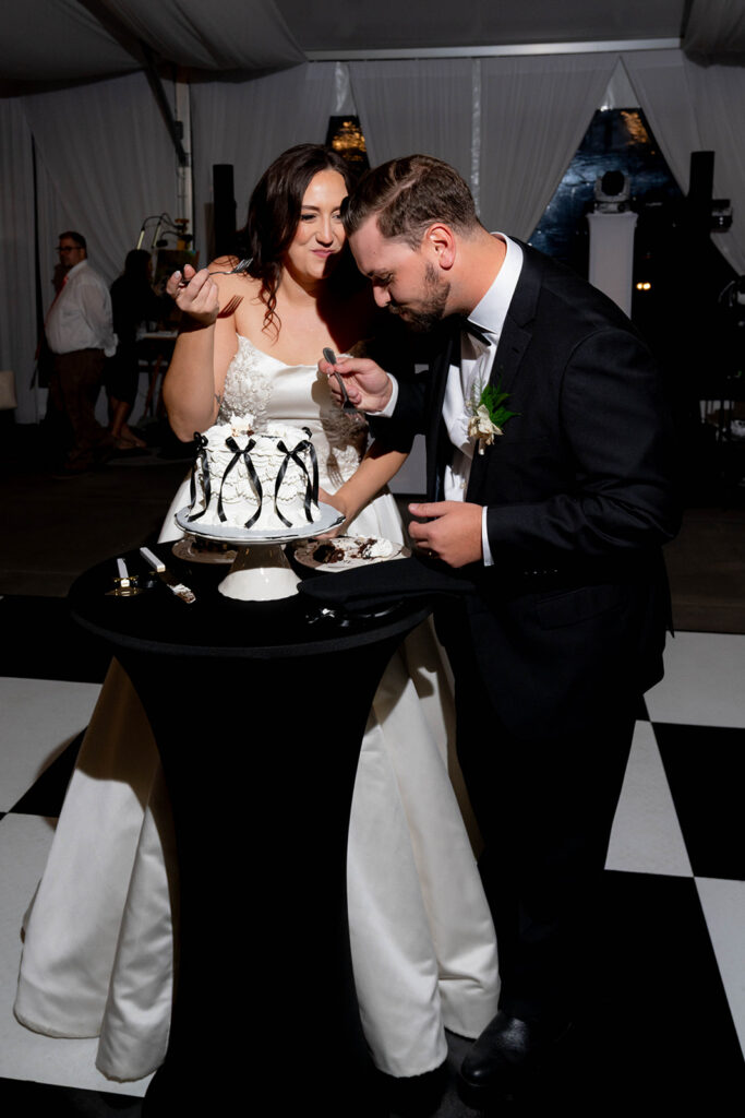 newlyweds trying their wedding cake