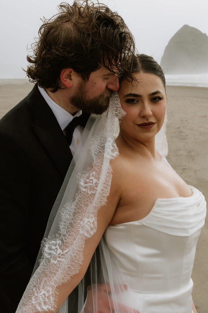 groom kissing the bride on the cheek