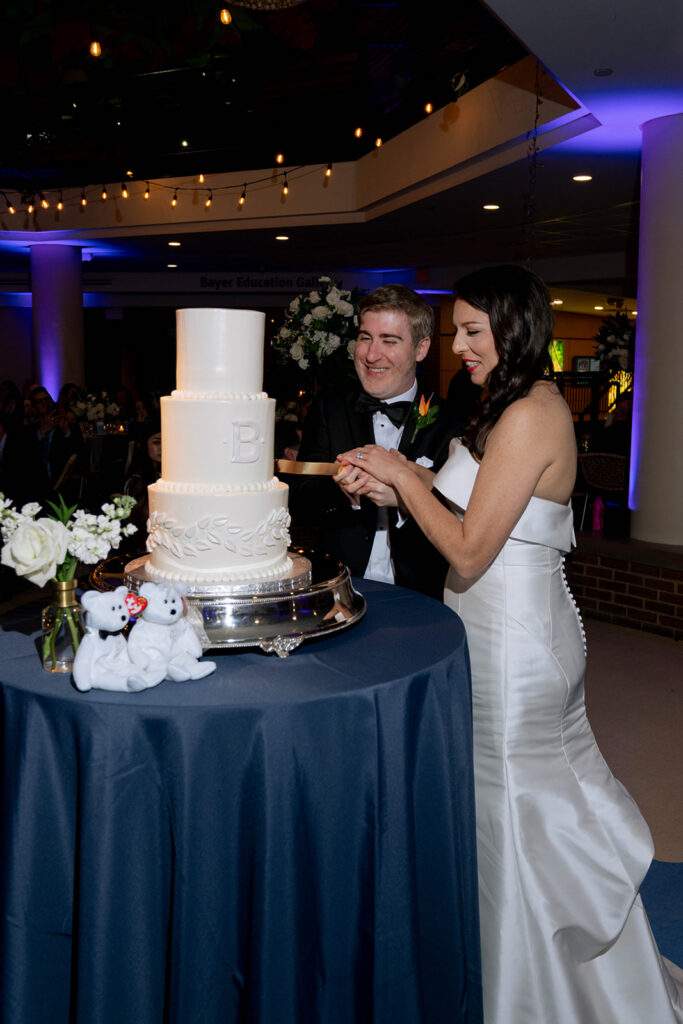 newly married couple cutting their wedding cake