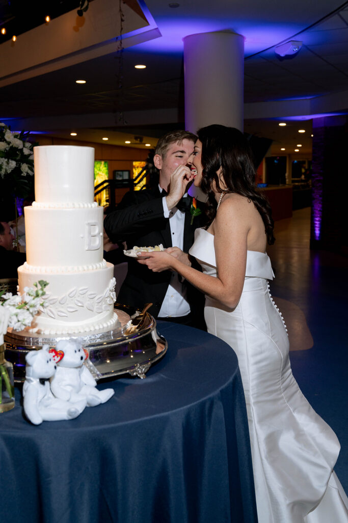 newlyweds trying their wedding cake