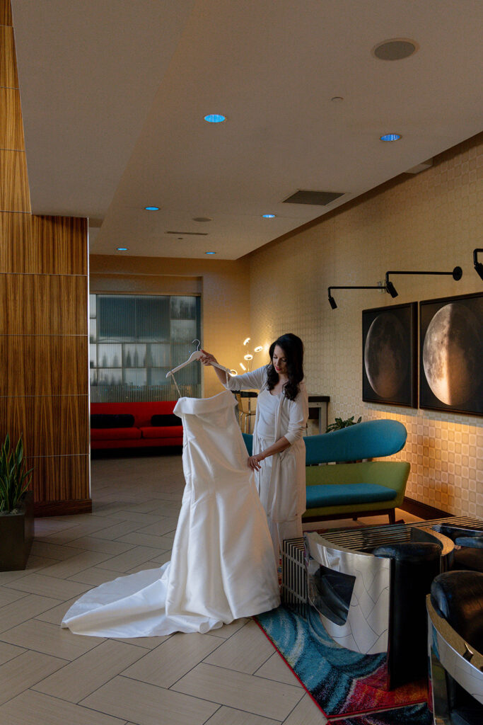 cute picture of the bride holding her wedding dress