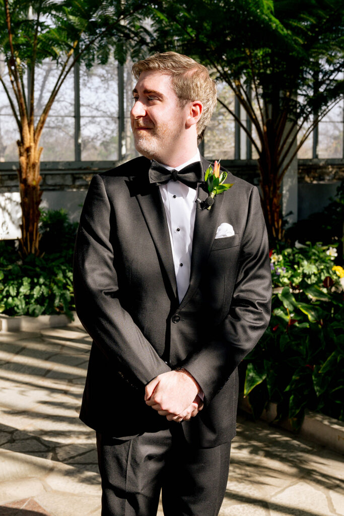 groom watching the bride walk down the aisle