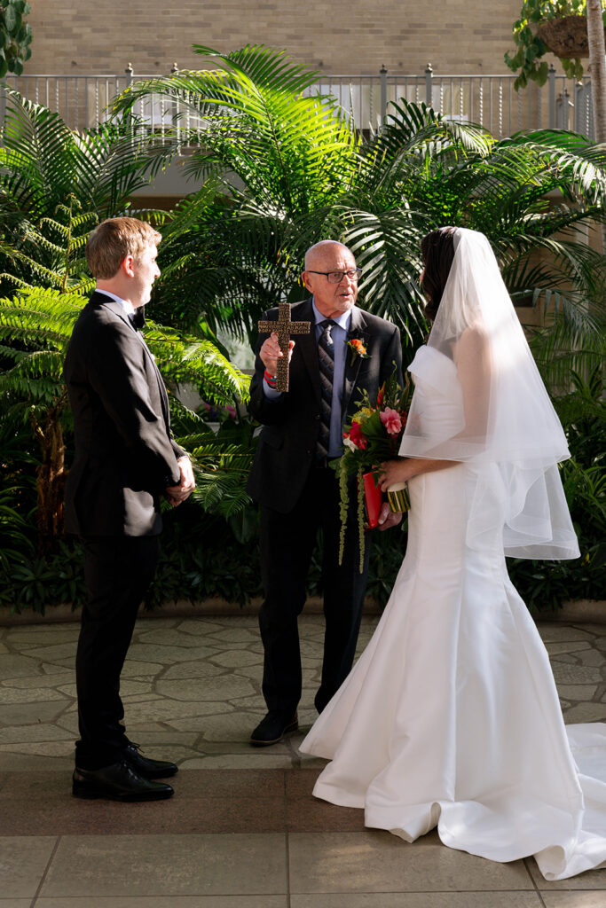 cute picture of the bride and groom holding hands during their ceremony