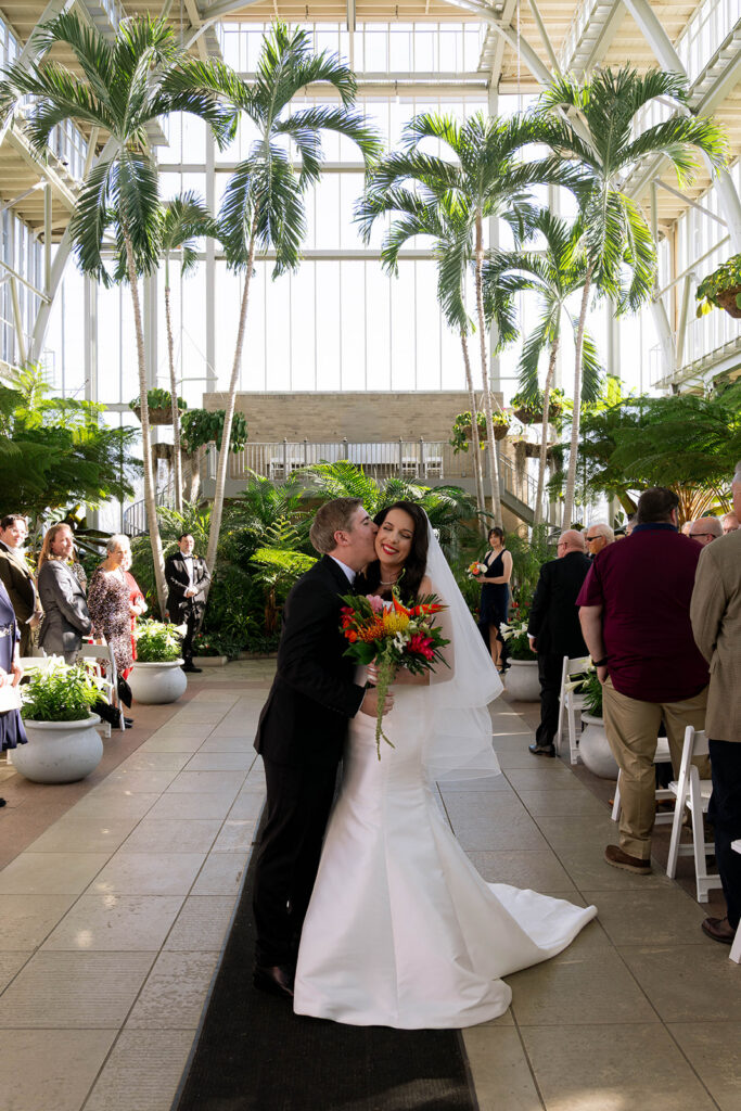 groom kissing the bride on the cheek