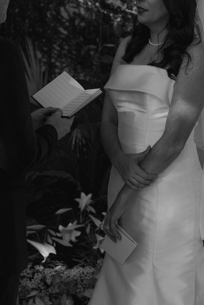 bride and groom reading their vows