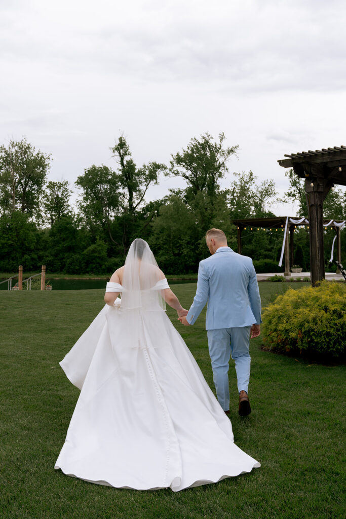 beautiful picture of the bride and groom holding hands