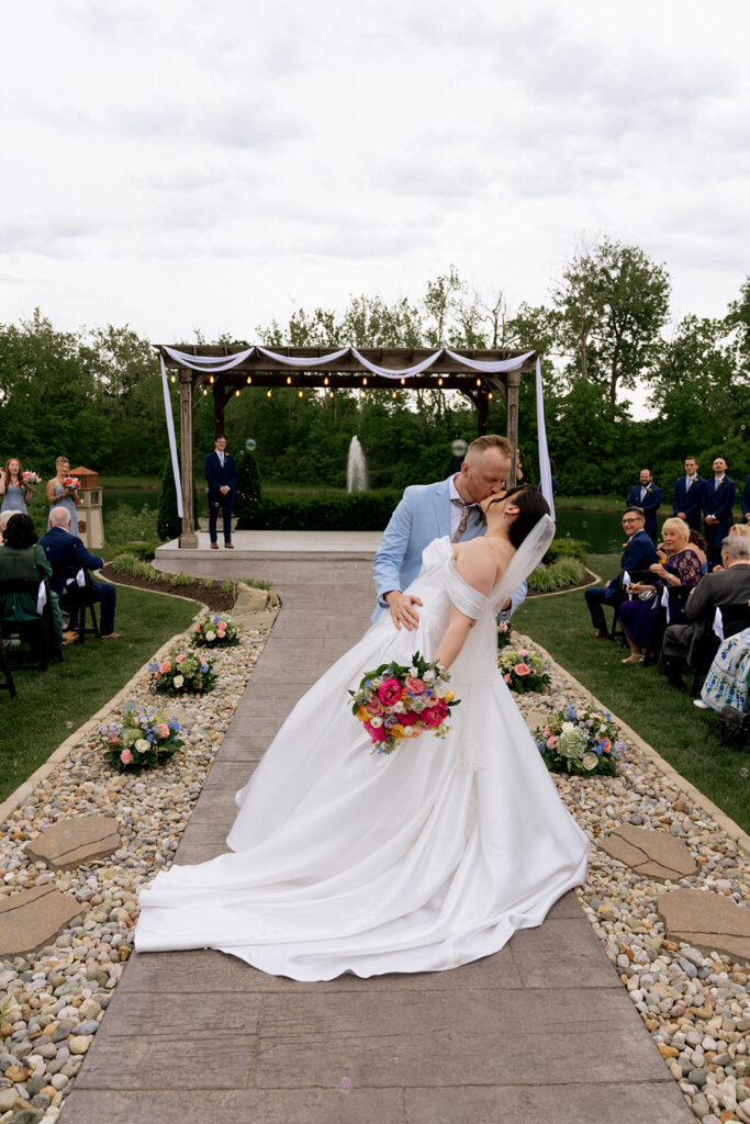 newlyweds kissing after their wedding ceremony