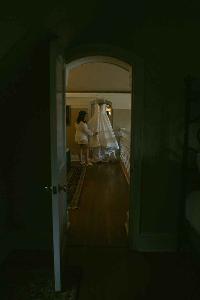 cute picture of the bride next to her wedding dress