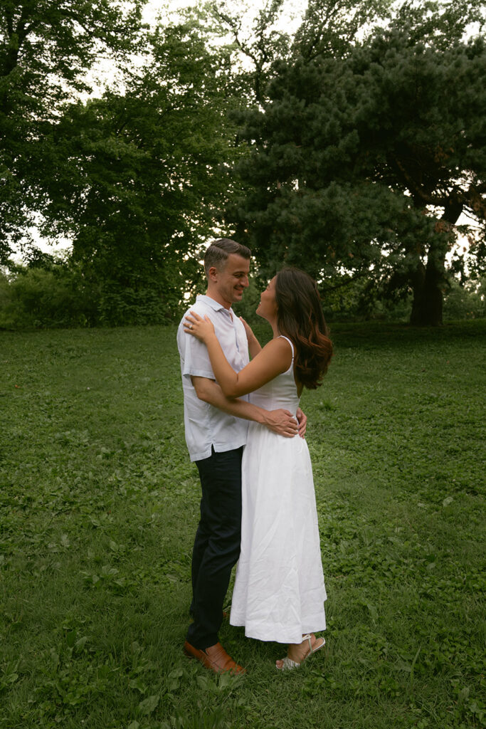 cute picture of the newly engaged couple smiling at each other
