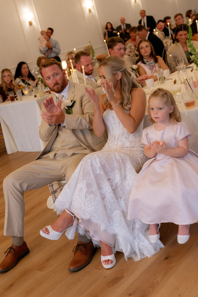newlyweds having the best time at their wedding reception