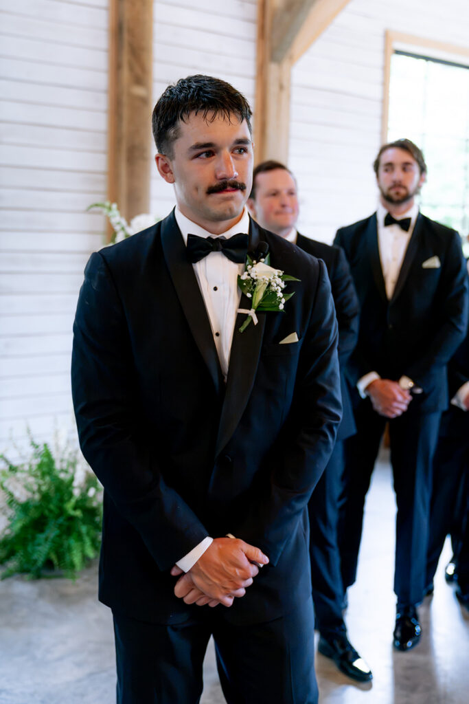groom emotional watching the bride walk down the aisle