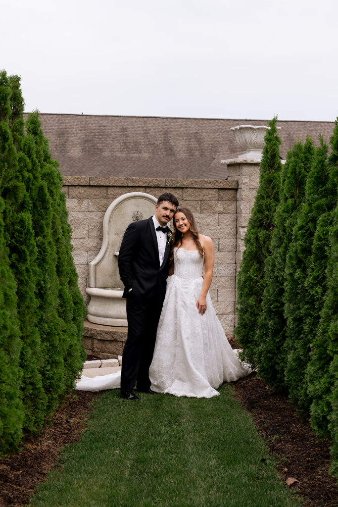newlyweds smiling at the camera during their photoshoot