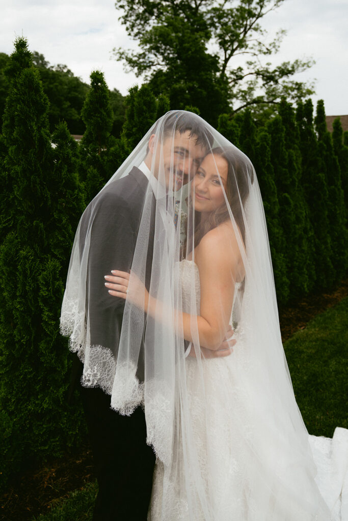 newlyweds smiling at the camera during their session