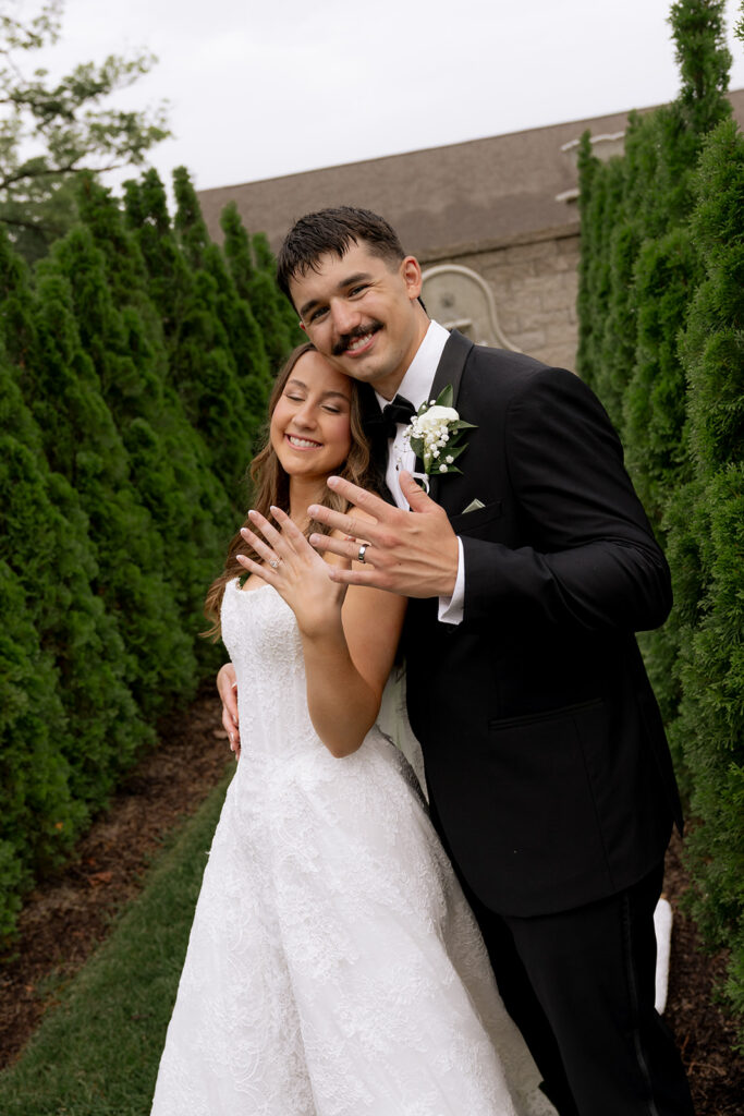 newlyweds showing their wedding rings